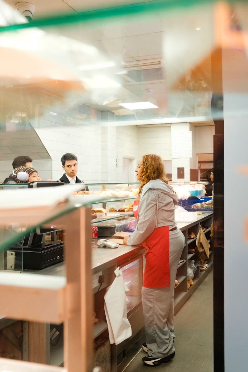 Customers queuing up and being served at a bakery