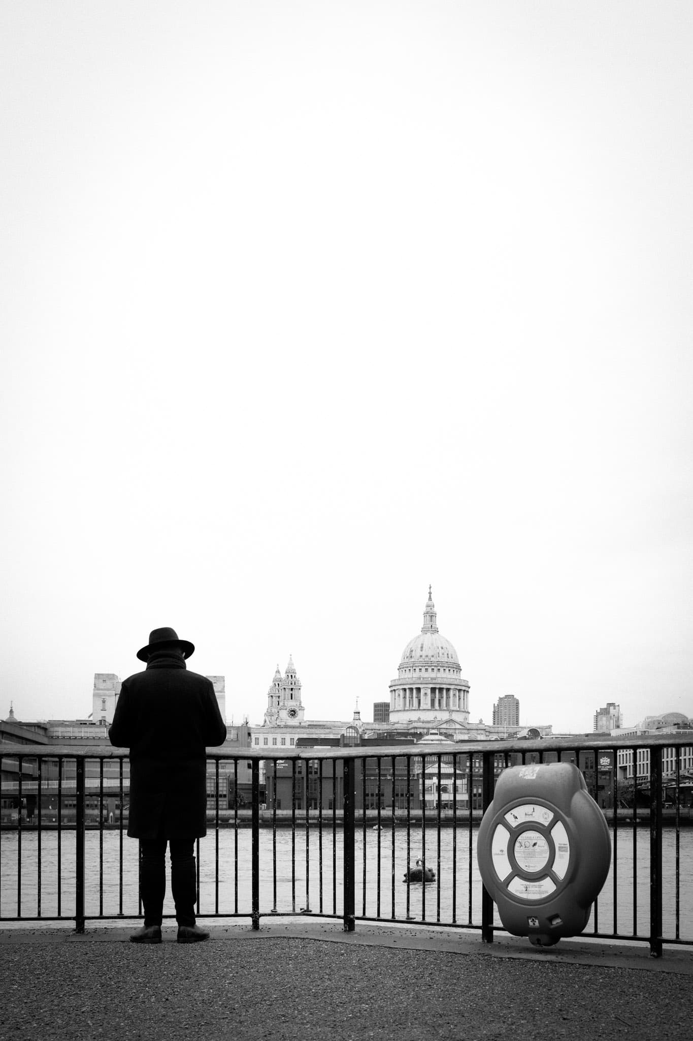 The silhouette of a person overlooking The Thames and St Paul's Cathedral (black and white)